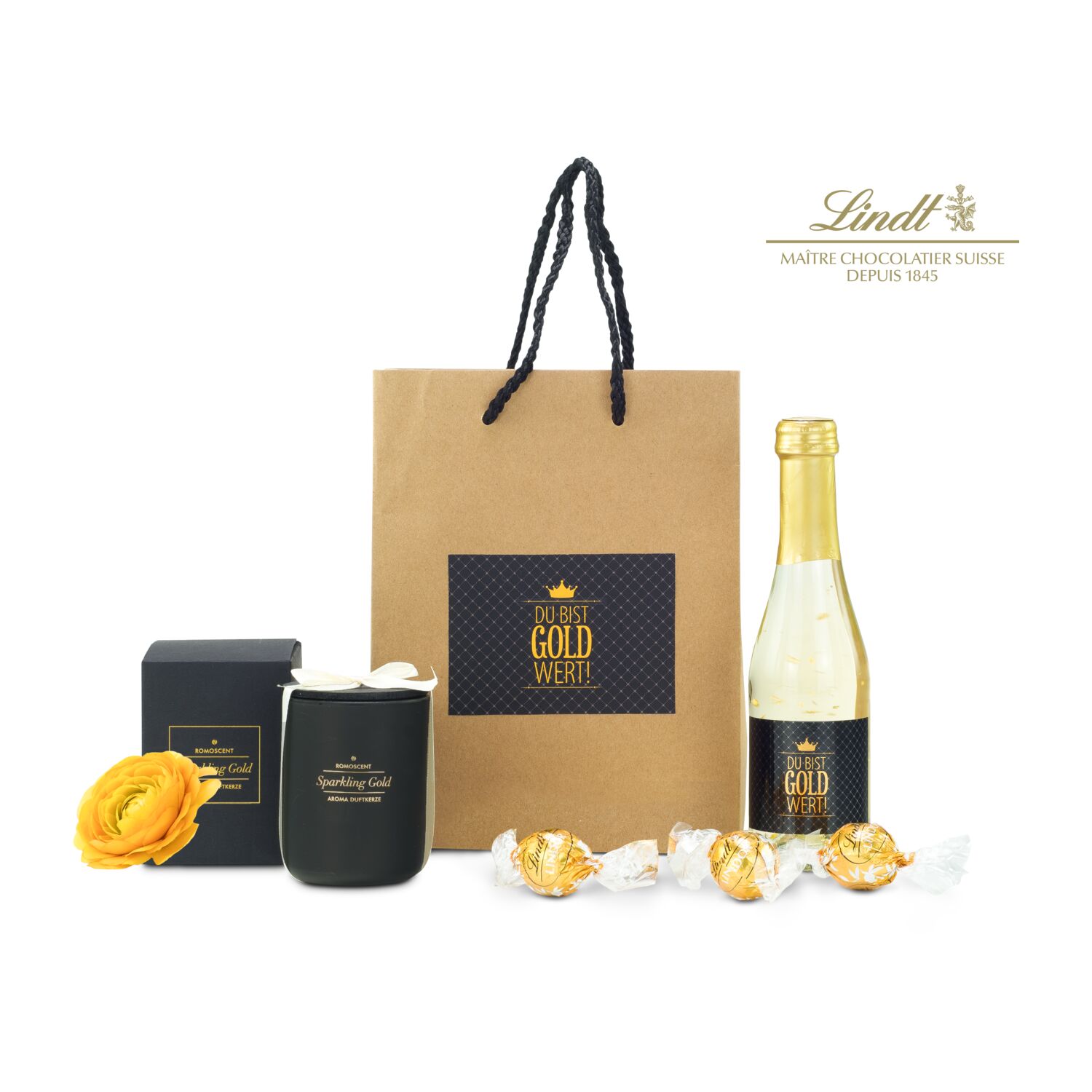 Die Tüte ist gefüllt mit "Du bist Gold wert" Secco (0,2 L), 3 goldenen Lindt Lindor Kugeln und einer ROMOSCENT® Sparkling Gold Duftkerze.